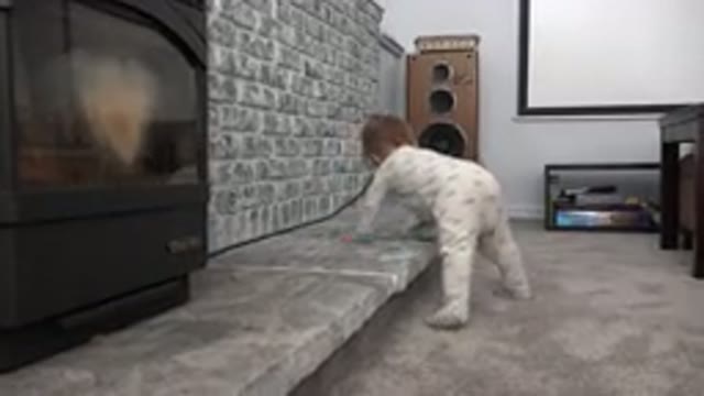 WESTMINSTER COLORADO-2015: Small Child Tries Moves Hands Along Fireplace