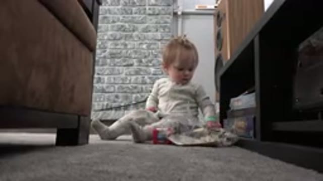 WESTMINSTER COLORADO-2015: A Blonde Haired Toddler Dressed In A Jumper Plays
