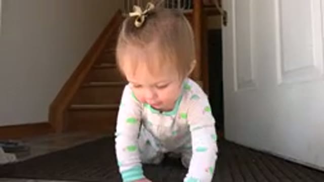 WESTMINSTER COLORADO-2015: A Cute Toddler Crawling From An Open White Door To