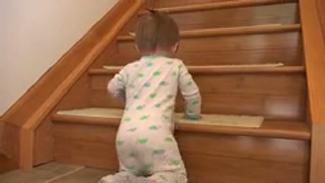 WESTMINSTER COLORADO-2015: A Little Girl Trying To Ascend A Wooden Staircase