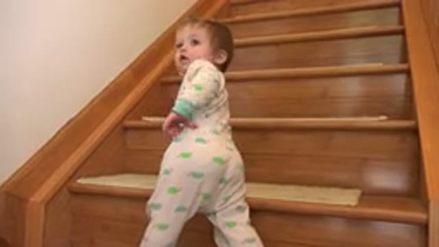 WESTMINSTER COLORADO-2015: Infant Wearing Green And White Sleeper Stands At