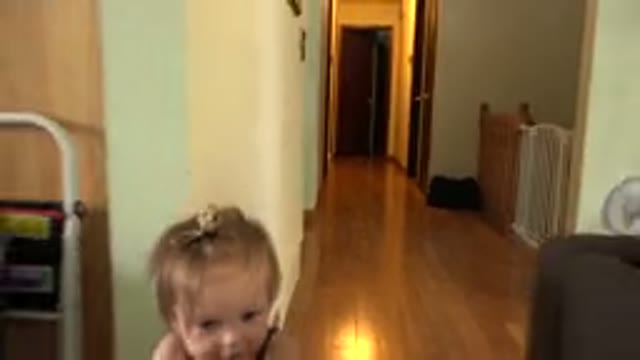 WESTMINSTER COLORADO-2015: Child Pushing Multicolored Trolley Inside A Room With