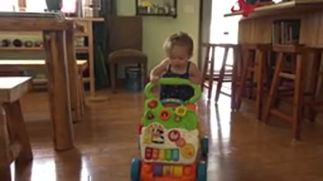 WESTMINSTER COLORADO-2015: Baby Playing On Wooden Floor With Toy With Training Wheels