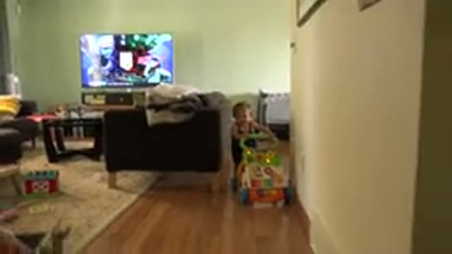 WESTMINSTER COLORADO-2015: Child Pushes Toy in Living Room with TV On
