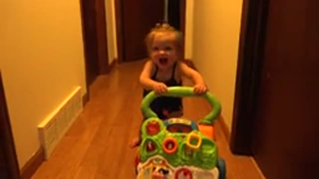 WESTMINSTER COLORADO-2015: A Young Female Toddler Pushing A Toy Cart Decorated With Cartoon Animals