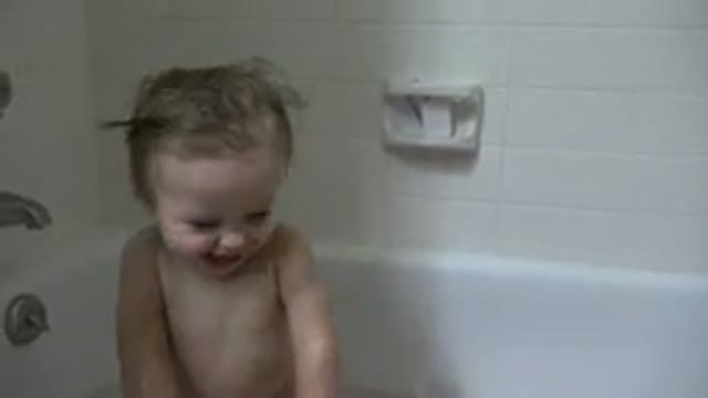 WESTMINSTER COLORADO-2015: Cute Smiling Little Girl In A Bathtub With A Hand Holding Pink Bowl