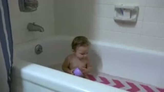 WESTMINSTER COLORADO-2015: Cute Toddler Sitting Naked In A Bathtub Holding Pink