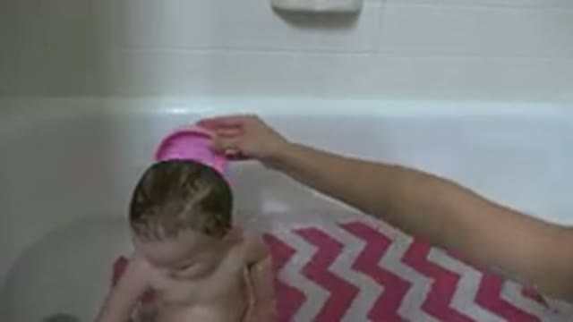 WESTMINSTER COLORADO-2015: A Baby Is Being Given A Bath By An Adult That Is Not