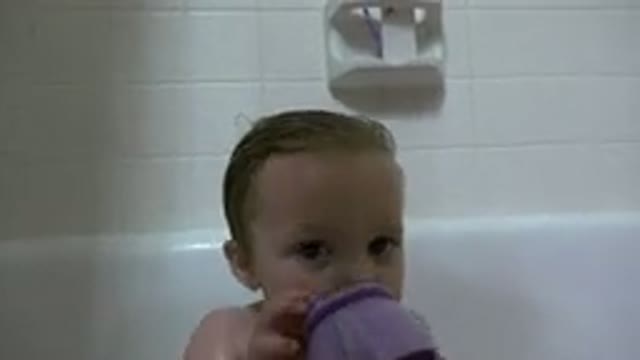 WESTMINSTER COLORADO-2015: Baby Boy Taking A Bath In A Bathtub And Playing With Water And Bottle