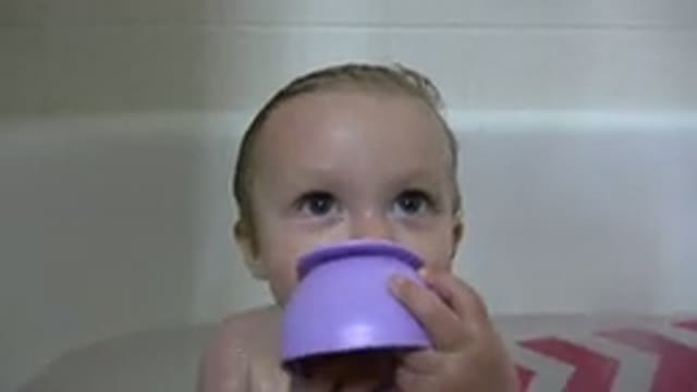 WESTMINSTER COLORADO-2015: Baby Playing With Purple Toy During Bath Inside