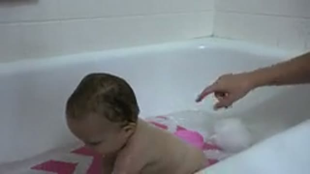 WESTMINSTER COLORADO-2015: Mother Bathing Her Baby in Bathtub with Water and Toys