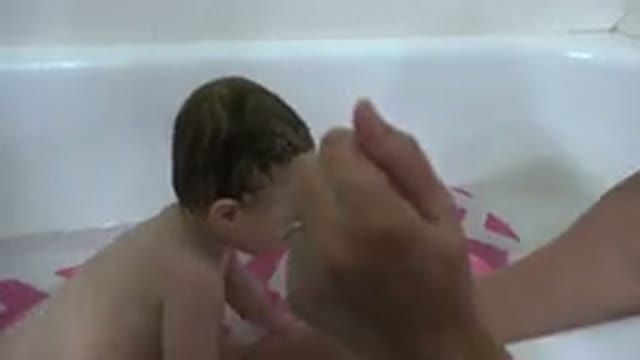 WESTMINSTER COLORADO-2015: Mother Bathing Baby In Bathtub With Non Slip Mat