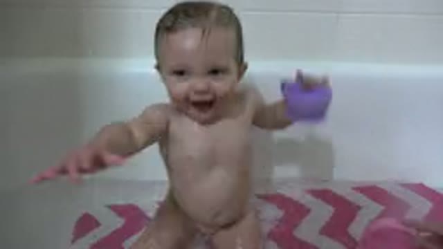 WESTMINSTER COLORADO-2015: Parent Bathing Child in Water with Pink and Purple Tones