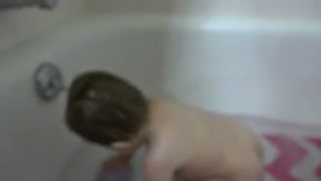WESTMINSTER COLORADO-2015: Infant In White Bathtub Picks Up Small Plastic Purple Cup