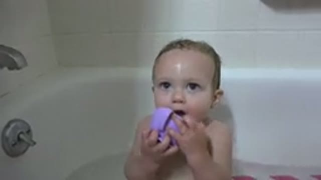 WESTMINSTER COLORADO-2015: A Baby Showering In A Bathtub Holding A Mug To Its Mouth