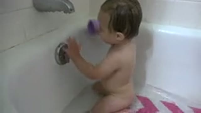 WESTMINSTER COLORADO-2015: Little Girl Sitting In The Bathtub And Playing With Water