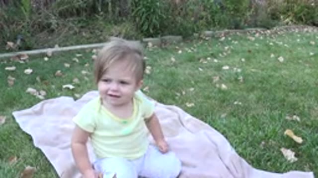 WESTMINSTER COLORADO-2015: A Little Girl Sat Outside On A Blanket On A Windy Day
