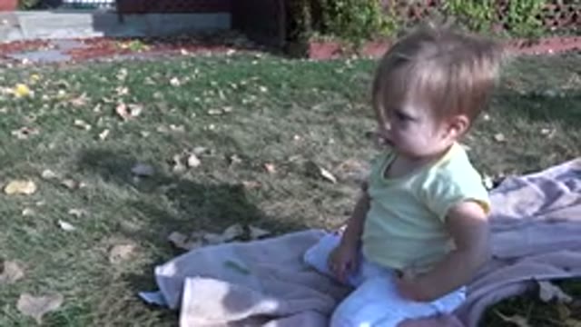 WESTMINSTER COLORADO-2015: Baby Sits On Towel In Grass Playing Alone Near Leaves