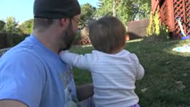 WESTMINSTER COLORADO-2015: Dad And Daughter Sitting In A Yard With Grass