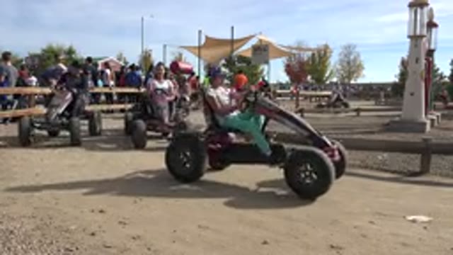 BRIGHTON COLORADO-2015: Children And Parents Riding Around On Manual Go-Karts On