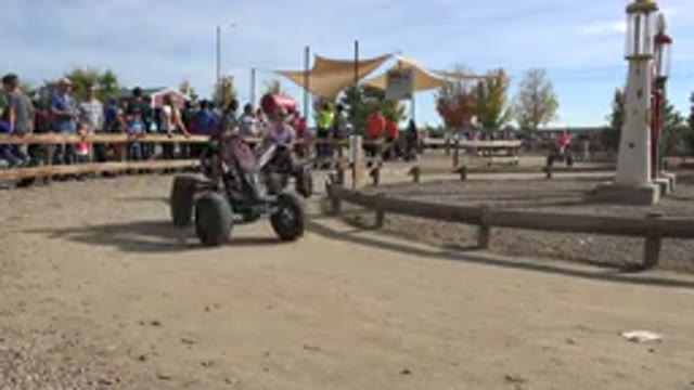 BRIGHTON COLORADO-2015: People Riding Circular Pedal Vehicles In A Loop