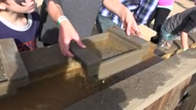 BRIGHTON COLORADO-2015: Children Sifting For Minerals In Trough Of Water On Field Trip