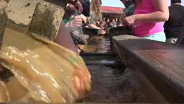 BRIGHTON COLORADO-2015: Workers Washing Some Beautiful Green Rock With Rushing Water