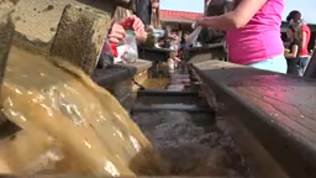 BRIGHTON COLORADO-2015: People Preparing Food In Dirty Water