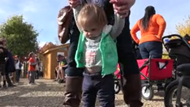 BRIGHTON COLORADO-2015: Person Assisting Toddler Walking Holding Hands
