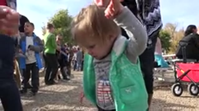 BRIGHTON COLORADO-2015: Little Girl Standing at a Social Gathering