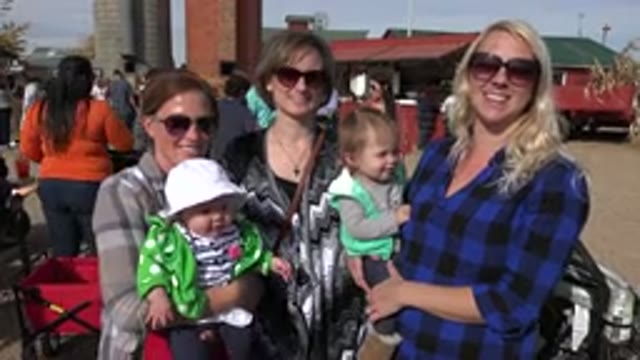 BRIGHTON COLORADO-2015: Three Women Smiling At Camera With Two Children In Their Arms
