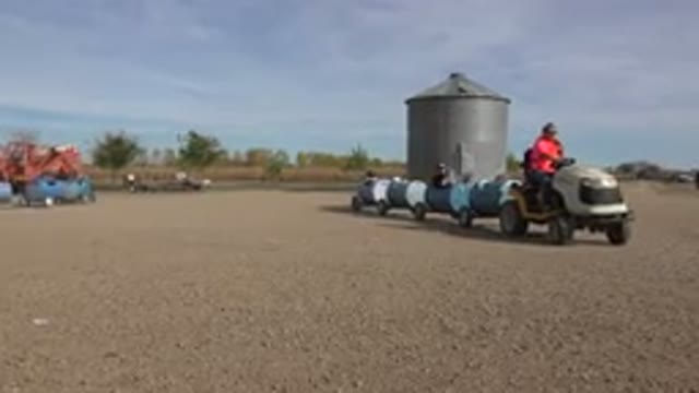 BRIGHTON COLORADO-2015: A Tractor Train of Six Cars with Families Inside Touring