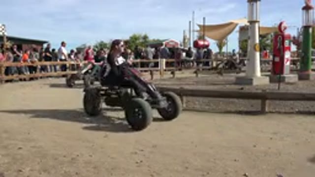 BRIGHTON COLORADO-2015: Several People Race Around A Round Track In Pedal-Driven Karts