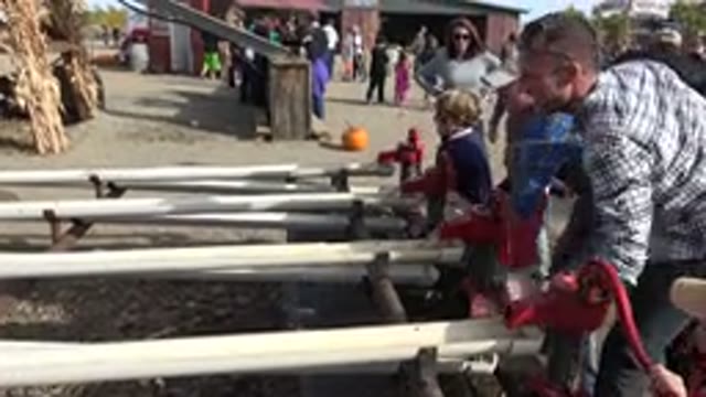 BRIGHTON COLORADO-2015: Man Shows Children How To Pump Water With Hand Crank At
