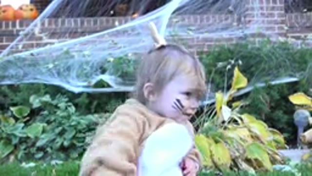 WESTMINSTER COLORADO-2015: Little Girl Sitting in a Yard Wearing a Costume