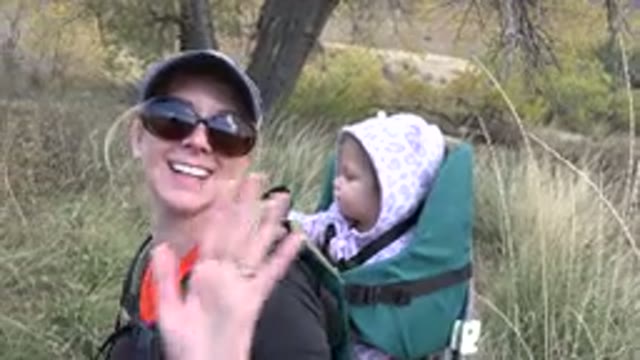 GOLDEN COLORADO-2015: Happy Mom and Curious Kid Waving at the Camera