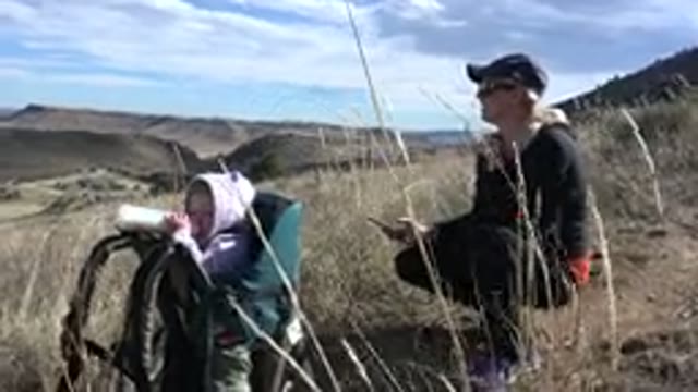 GOLDEN COLORADO-2015: Mom And Daughter Sitting In A Field Taking A Break From Hiking
