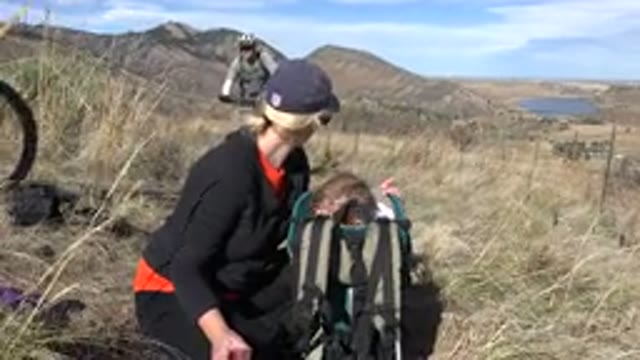 GOLDEN COLORADO-2015: Mom And Daughter Sitting In A Field On A Hike