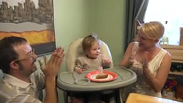 WESTMINSTER COLORADO-2015: Man And Woman Clap For Toddler Sitting In White Padded Highchair