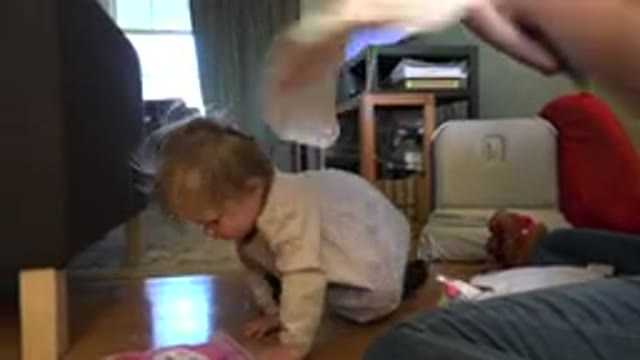 WESTMINSTER COLORADO-2015: Baby Playing On Ground While Mom Folds Clothes