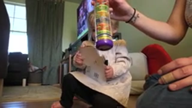 WESTMINSTER COLORADO-2015: Baby Holding A Card And A Woman Showing Her A Toy