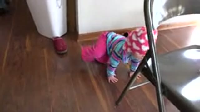 PRAIRIE GROVE ILLINOIS-2015: Baby Crawling Learning To Get Up To Stand On A Chair
