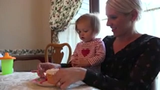 PRAIRIE GROVE ILLINOIS-2015: Mom And Little Girl Play With Cupcake At Kitchen