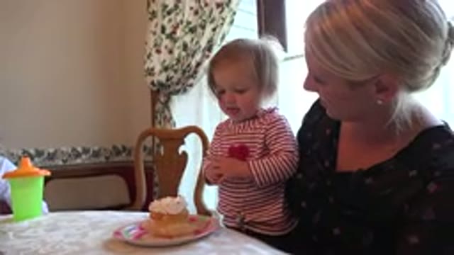 PRAIRIE GROVE ILLINOIS-2015: Child Looks Hungrily At Cupcake Until Woman Offers