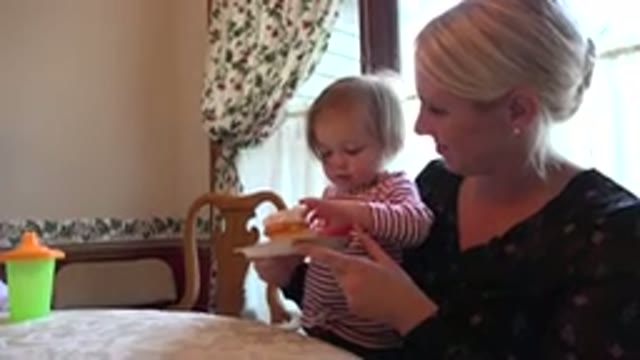 PRAIRIE GROVE ILLINOIS-2015: Little Girl Eating A Cupcake With Her Mom