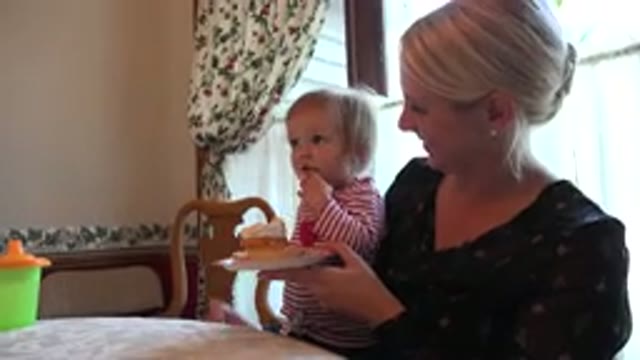 PRAIRIE GROVE ILLINOIS-2015: Toddlers Sitting on Mother's Lap Eating a Piece of Cream Cake