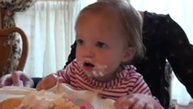PRAIRIE GROVE ILLINOIS-2015: A Child With A Messy Face Tries To Lick Cream From Their Fingers