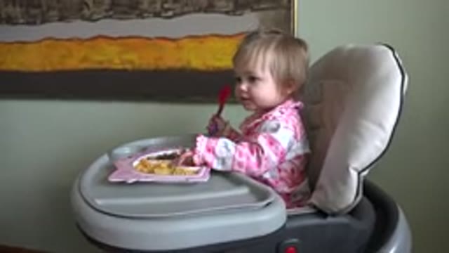 WESTMINSTER COLORADO-2015: Baby Girl in a Baby Chair Eating with an Art Frame