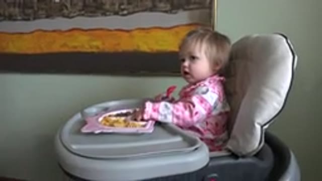 WESTMINSTER COLORADO-2015: A Cute Little Girl Eating Food At A Booster Seat And
