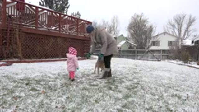 WESTMINSTER COLORADO-2015: Mother Encouraging Her Daughter To Play In The Snow